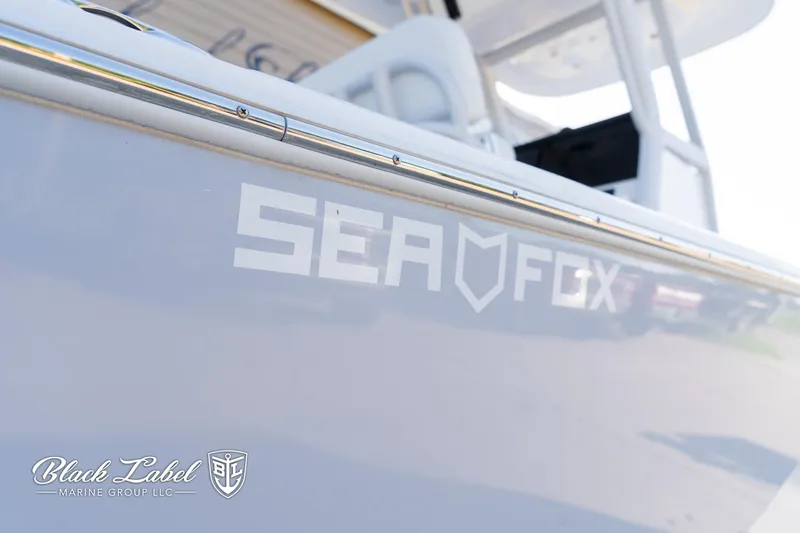 Slide: The Image of 2024 Sea Fox 231 Bay Fox Center Console boat, sleek design, Black Label Marine Group logo. - 3
