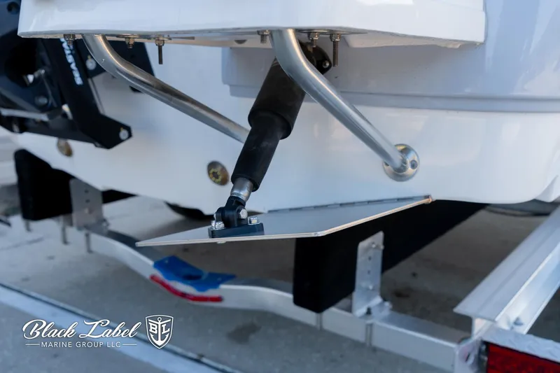 Slide: The Image of 2024 Sea Fox 231 Bay Fox Center Console boat on trailer, featuring trim tab detail. - 7
