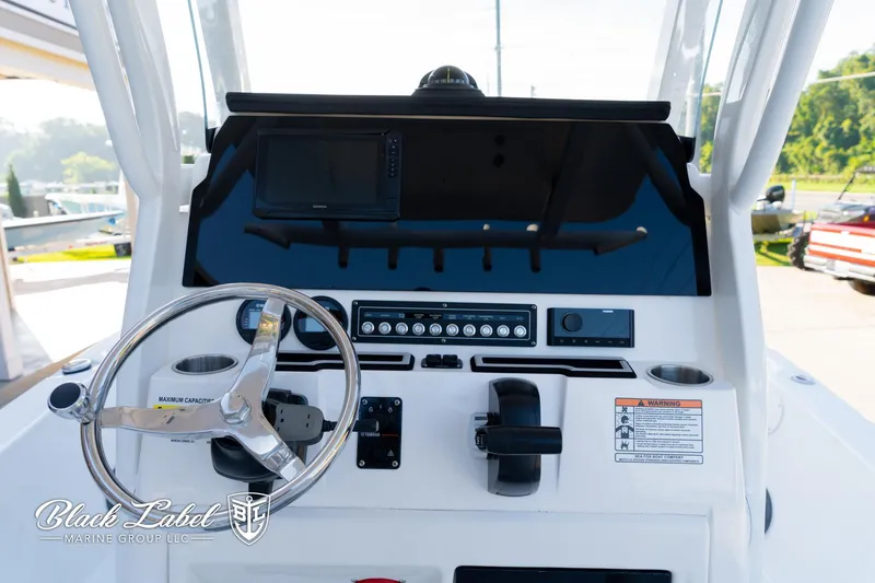 Slide: The Image of 2024 Sea Fox 251 BayFox Center Console dashboard with steering wheel and controls. - 17