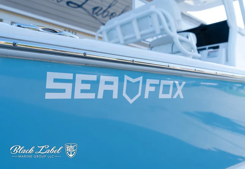 Slide: The Image of 2024 Sea Fox 251 BayFox Center Console boat, blue hull, Black Label Marine Group branding. - 3
