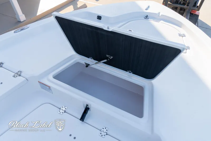 Slide: The Image of 2024 Sea Fox 251 BayFox Center Console storage compartment open on deck. - 9