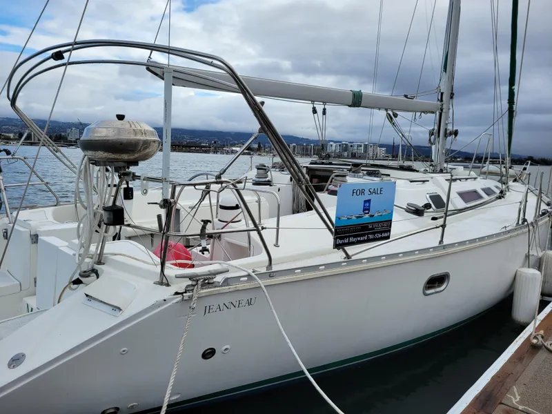 The Image of 1994 Jeanneau Sun Odyssey 51 sailboat docked, for sale sign visible. - 0