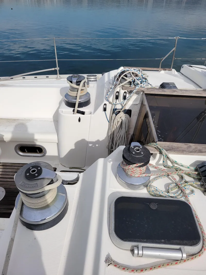 Slide: The Image of Deck of 1994 Jeanneau Sun Odyssey 51 sailboat with winches and ropes. - 12