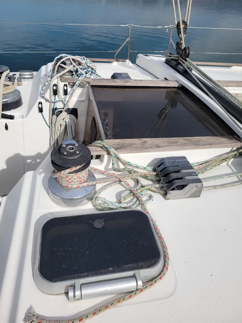 Slide: The Image of Deck of 1994 Jeanneau Sun Odyssey 51 sailboat with ropes and winch. - 13