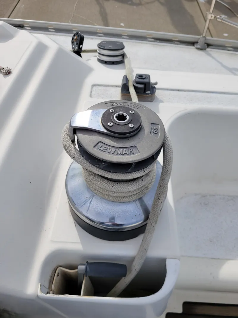 Slide: The Image of Winch on 1994 Jeanneau Sun Odyssey 51 sailboat deck, featuring Lewmar branding. - 15