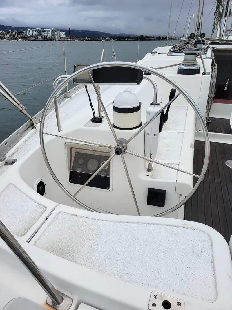 Slide: The Image of Steering wheel of a 1994 Jeanneau Sun Odyssey 51 sailboat on calm water. - 16