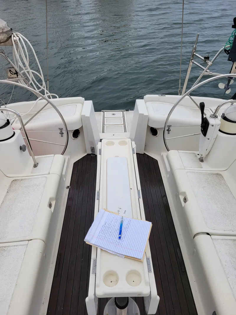 Slide: The Image of Cockpit of 1994 Jeanneau Sun Odyssey 51 sailboat with notebook and pen on table. - 17