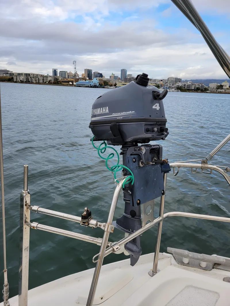 Slide: The Image of Yamaha outboard motor on Jeanneau Sun Odyssey 51 sailboat, 1994 model, docked in urban harbor. - 18