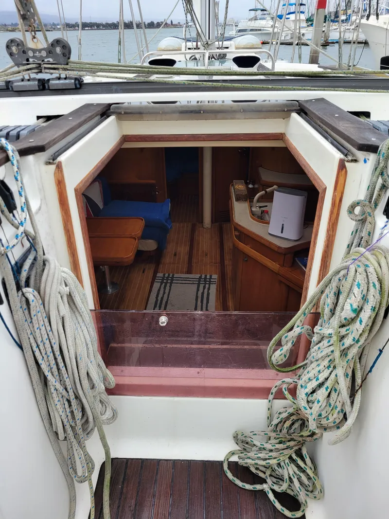 Slide: The Image of 1994 Jeanneau Sun Odyssey 51 yacht interior with ropes and wooden flooring. - 19
