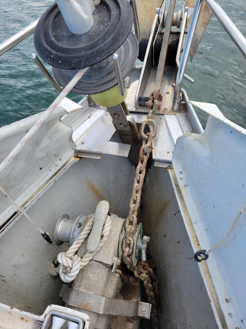 Slide: The Image of Anchor chain and windlass on a 1994 Jeanneau Sun Odyssey 51 sailboat. - 2