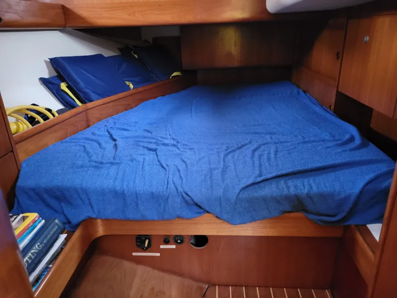 Slide: The Image of Cozy cabin bed in 1994 Jeanneau Sun Odyssey 51 sailboat with blue bedding. - 22