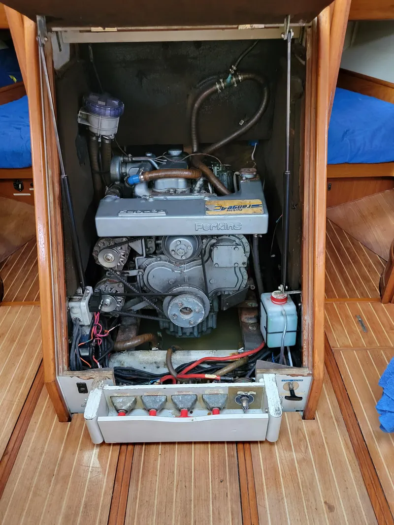 Slide: The Image of Engine compartment of a 1994 Jeanneau Sun Odyssey 51 sailboat, showcasing the motor and components. - 23