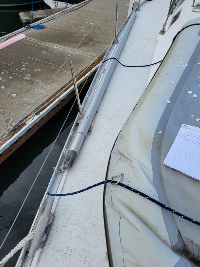 Slide: The Image of Deck view of a 1994 Jeanneau Sun Odyssey 51 sailboat docked at a marina. - 3