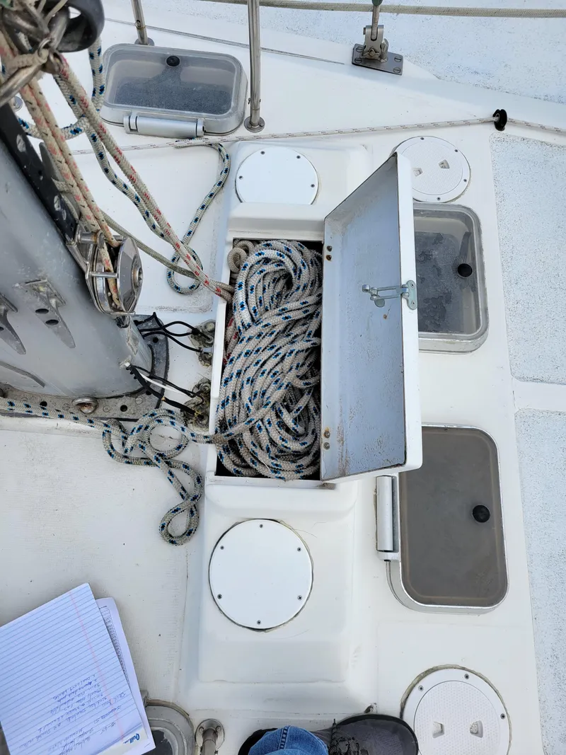 Slide: The Image of Deck of 1994 Jeanneau Sun Odyssey 51 with open rope storage compartment. - 4
