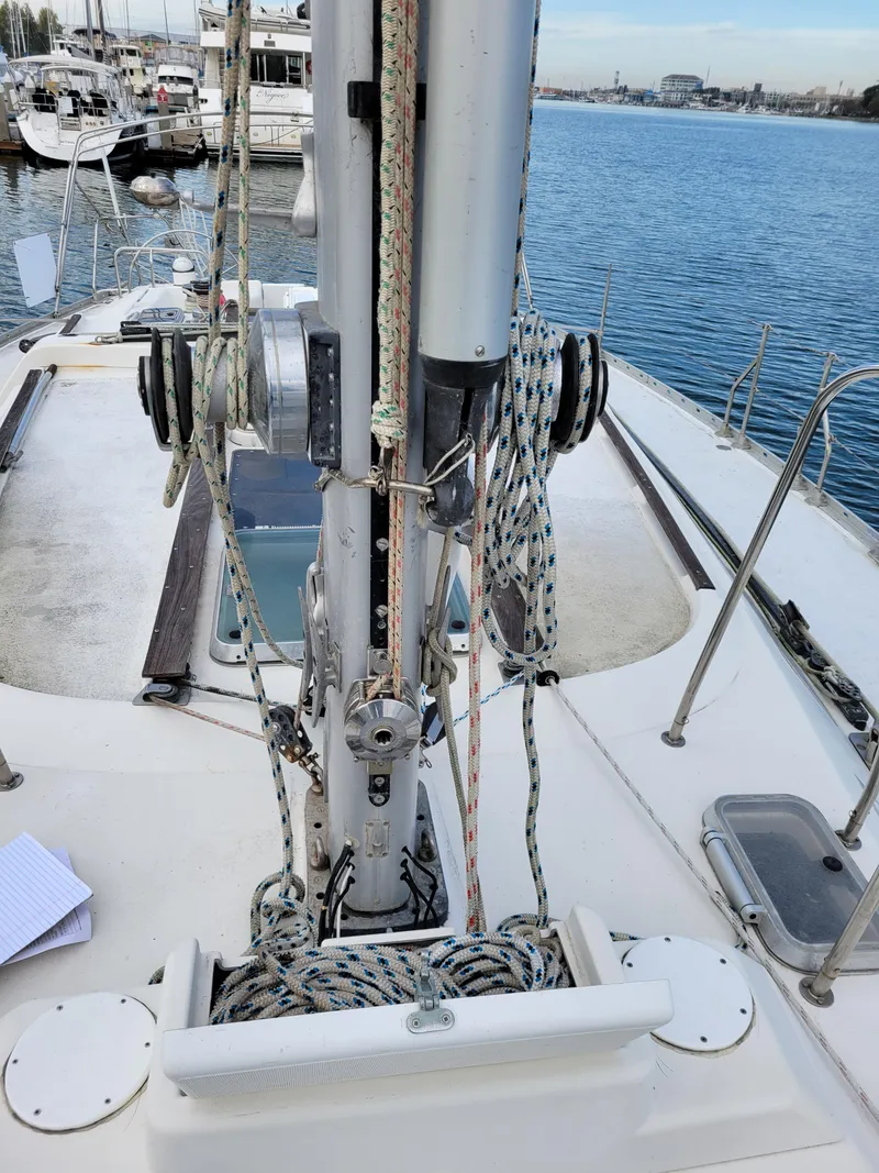 Slide: The Image of Jeanneau Sun Odyssey 51 sailboat deck with rigging, docked in a marina, 1994 model. - 5