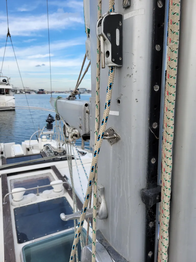 Slide: The Image of Close-up of Jeanneau Sun Odyssey 51 sailboat mast and rigging, docked in a marina. - 6