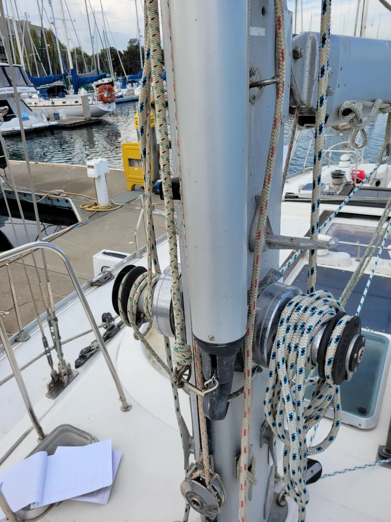 Slide: The Image of Jeanneau Sun Odyssey 51 sailboat deck with rigging, docked at marina, 1994 model. - 7