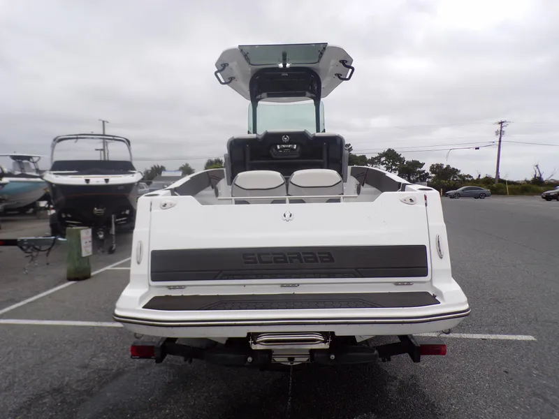 Slide: The Image of 2023 Scarab 255 Open ID boat rear view in a parking lot. - 4