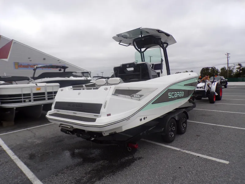 Slide: The Image of 2023 Scarab 255 Open ID boat on a trailer in a parking lot. - 5