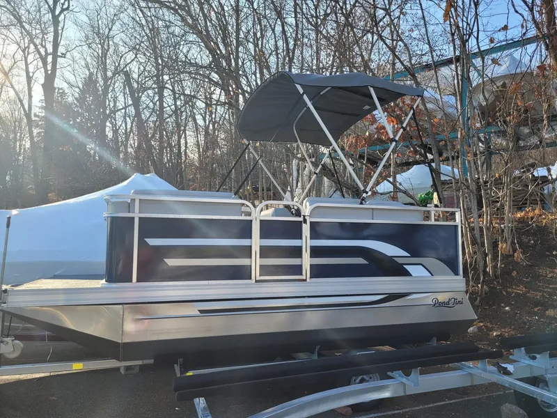 The Image of 2024 Pond-Tini Series 14 pontoon boat with canopy in wooded area. - 0