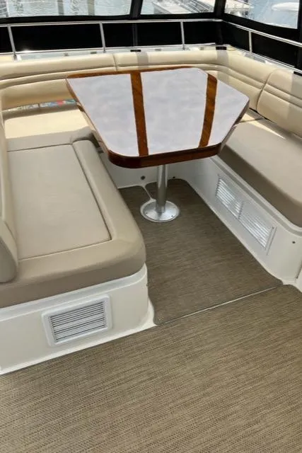 Slide: The Image of Luxurious seating area on 2016 Sea Ray 510 Fly yacht with wooden table. - 33