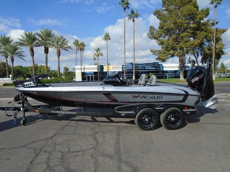 Slide: The Image of 2024 Vexus VX20 boat on trailer, parked outdoors with palm trees in the background. - 4
