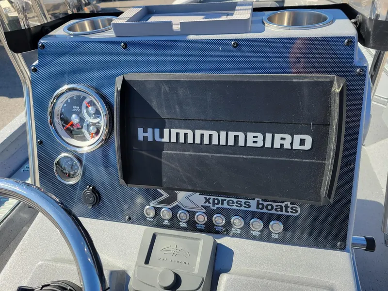 Slide: The Image of 2024 Xpress H24 Bay boat dashboard with Humminbird display and gauges. - 11
