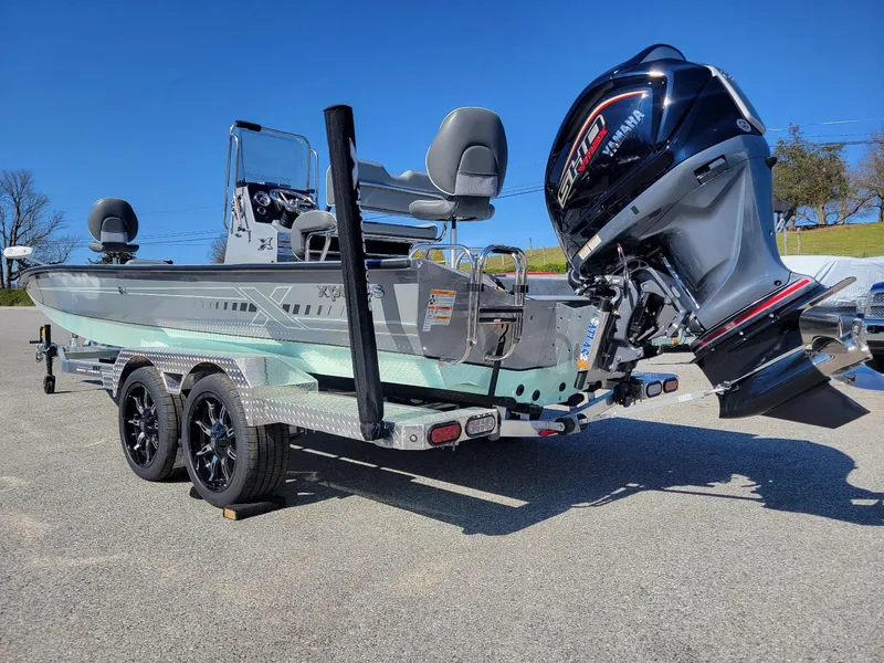 Slide: The Image of 2024 Xpress H24 Bay boat on trailer with Yamaha outboard motor. - 12