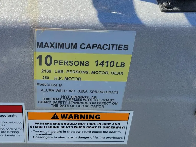 Slide: The Image of 2024 Xpress H24 Bay boat capacity label, 10 persons, 1410 lbs, 250 HP motor. - 13