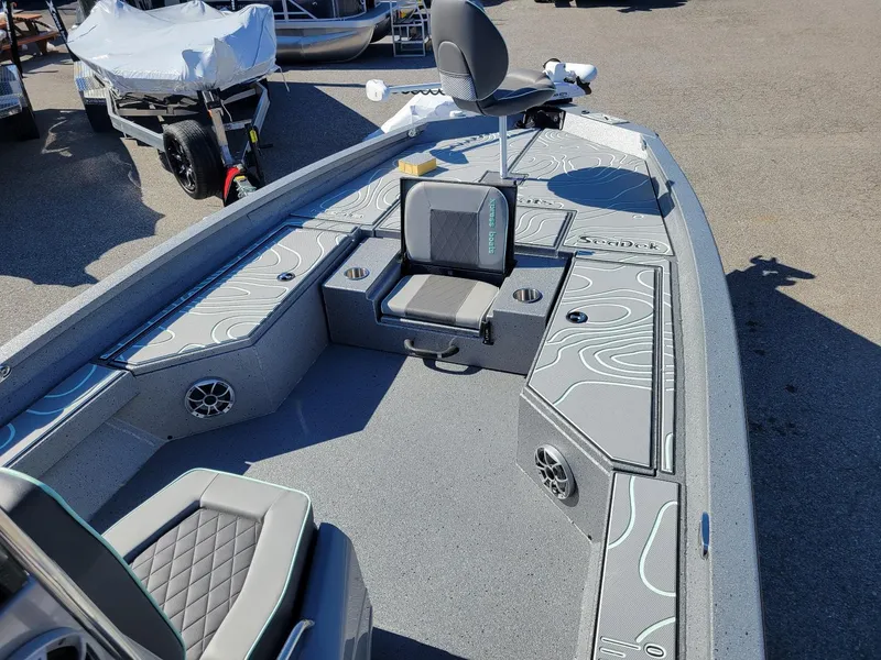 Slide: The Image of 2024 Xpress H24 Bay boat interior with seating and storage compartments. - 14