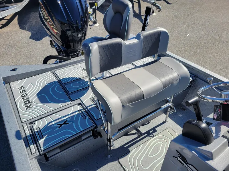 Slide: The Image of 2024 Xpress H24 Bay boat interior with seating and motor, in stock. - 16