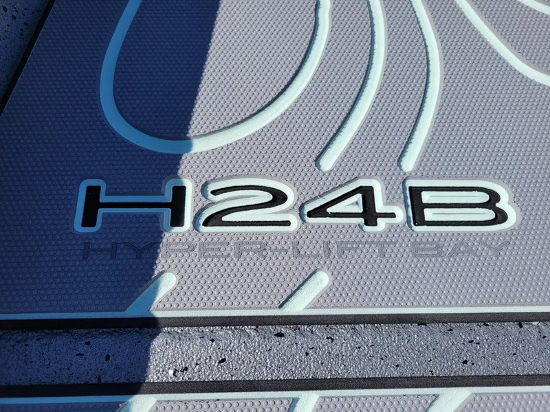 Slide: The Image of 2024 Xpress H24 Bay boat deck with H24B Hyper-Lift Bay logo. - 5