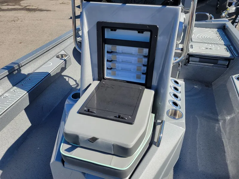 Slide: The Image of 2024 Xpress H24 Bay boat interior with storage compartments and seating. - 8