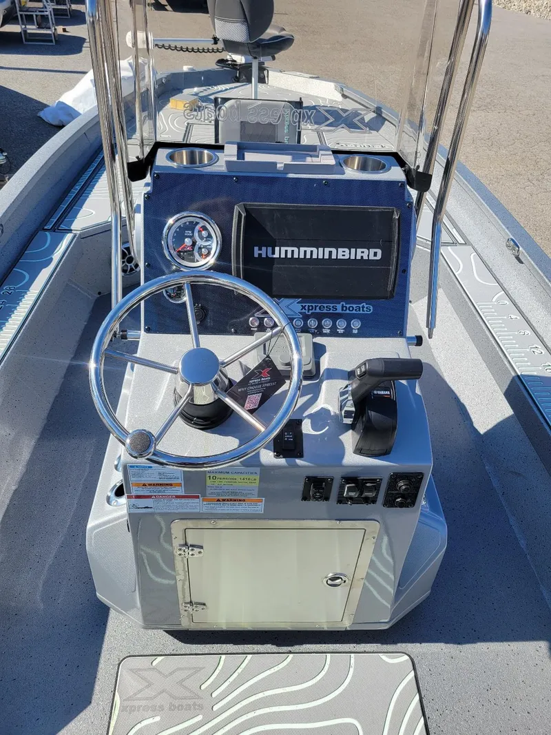 Slide: The Image of 2024 Xpress H24 Bay boat dashboard with Humminbird electronics and steering wheel. - 9