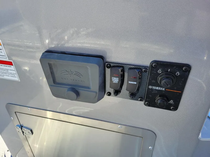 Slide: The Image of Control panel of 2024 Xpress X23 Bay Lounge boat with Yamaha switches. - 10