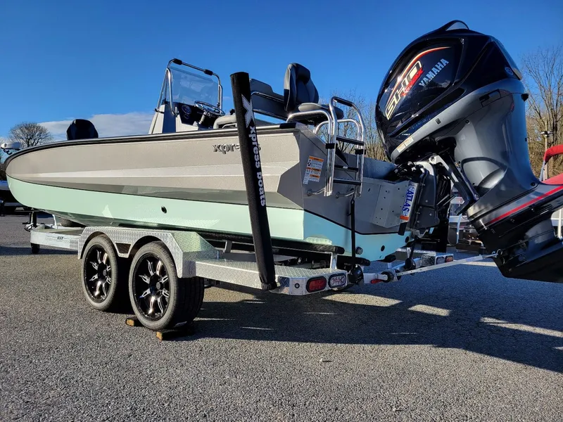 Slide: The Image of 2024 Xpress X23 Bay Lounge boat with Yamaha engine on trailer, sunny day. - 13