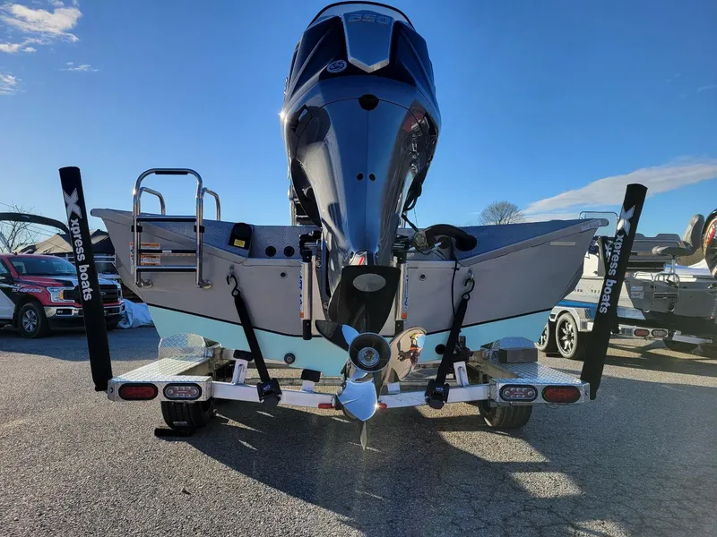 Slide: The Image of 2024 Xpress X23 Bay Lounge boat on trailer, rear view, sunny day. - 16