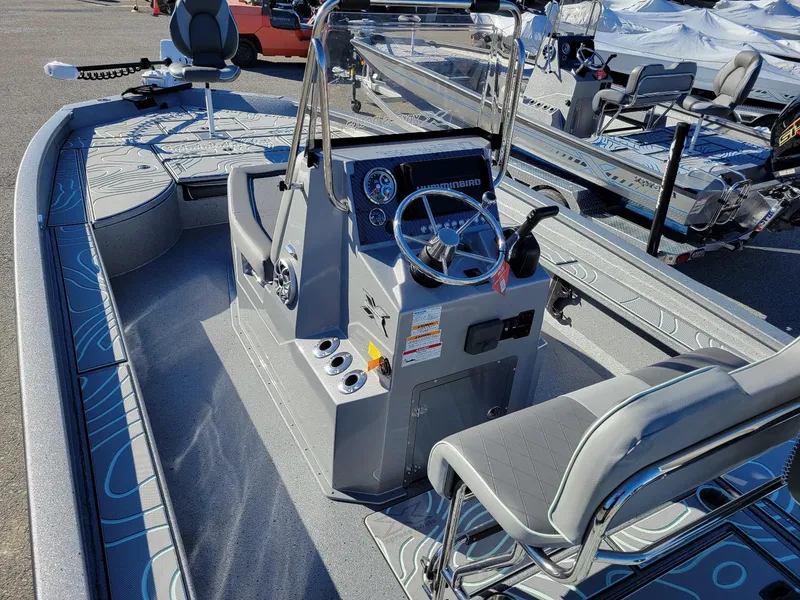 Slide: The Image of 2024 Xpress X23 Bay Lounge boat interior with steering console and seating, demo model. - 18