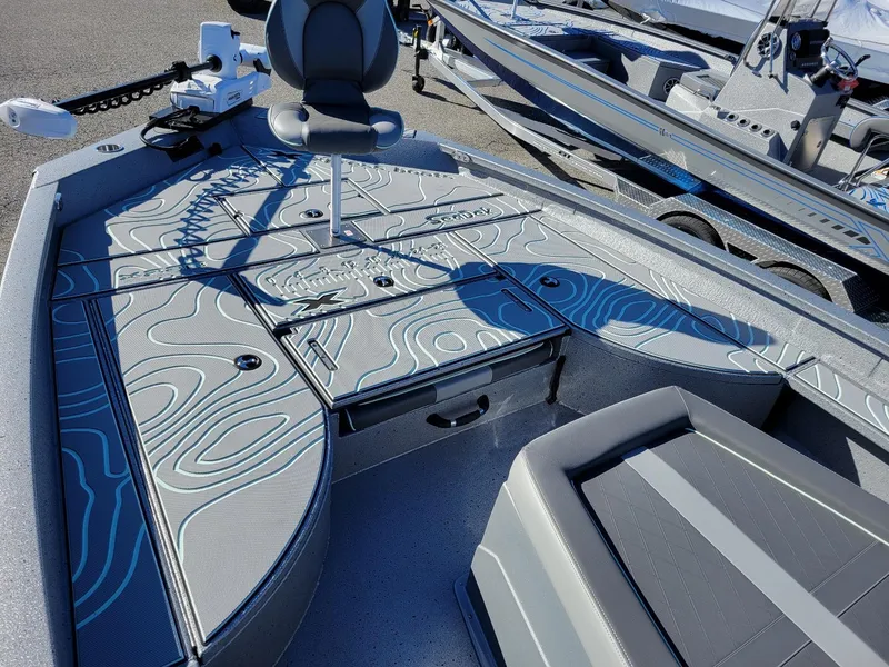 Slide: The Image of 2024 Xpress X23 Bay Lounge boat interior with modern seating and storage compartments. - 19