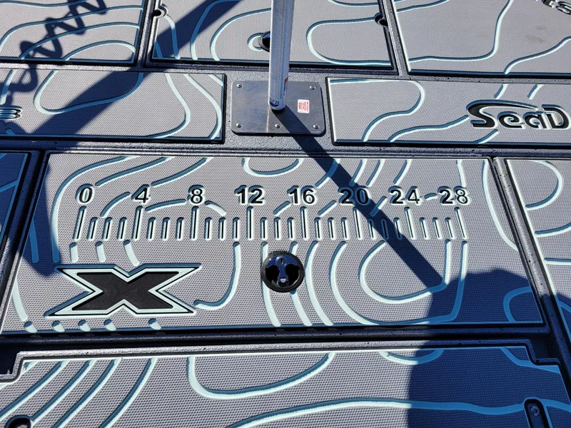 Slide: The Image of 2024 Xpress X23 Bay Lounge boat deck with measurement markings and SeaDek pattern. - 21