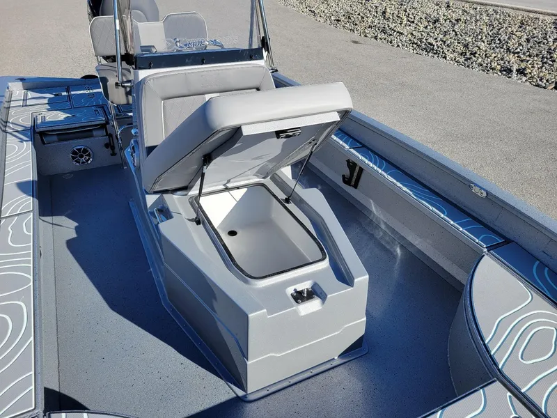 Slide: The Image of 2024 Xpress X23 Bay Lounge boat interior with open storage compartment. - 23