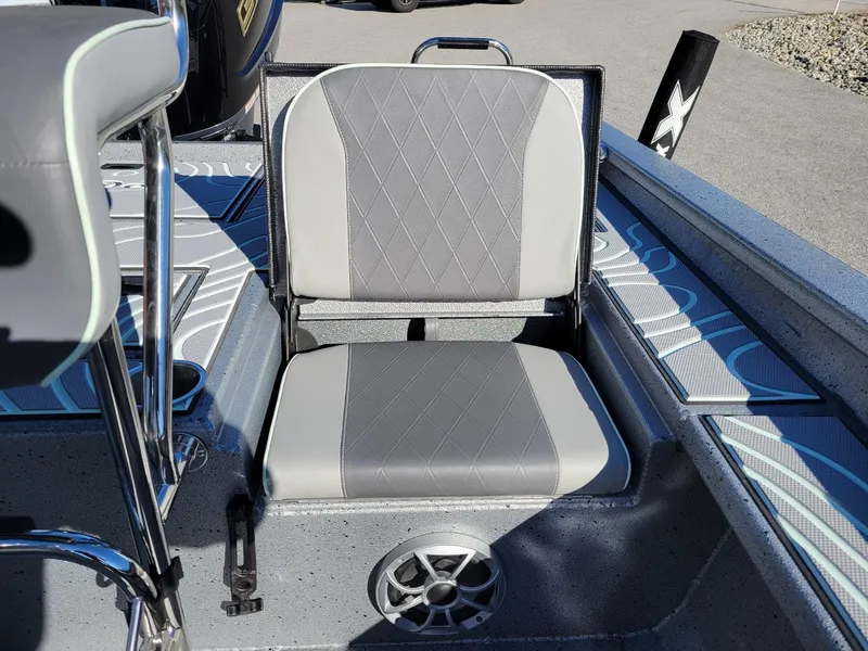 Slide: The Image of 2024 Xpress X23 Bay Lounge boat seat with gray upholstery and speaker. - 24