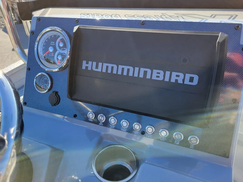 Slide: The Image of Dashboard of 2024 Xpress X23 Bay Lounge with Humminbird display and gauges. - 25