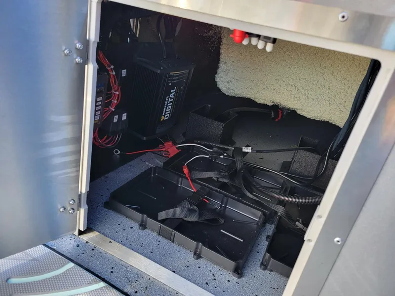 Slide: The Image of 2024 Xpress X23 Bay Lounge interior wiring and battery compartment. - 26