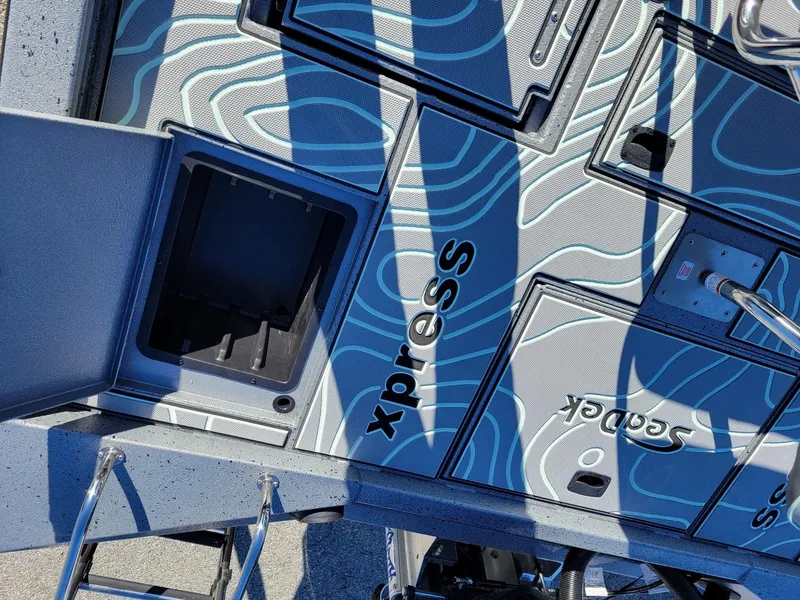 Slide: The Image of 2024 Xpress X23 Bay Lounge boat deck with storage compartments and stylish design. - 27