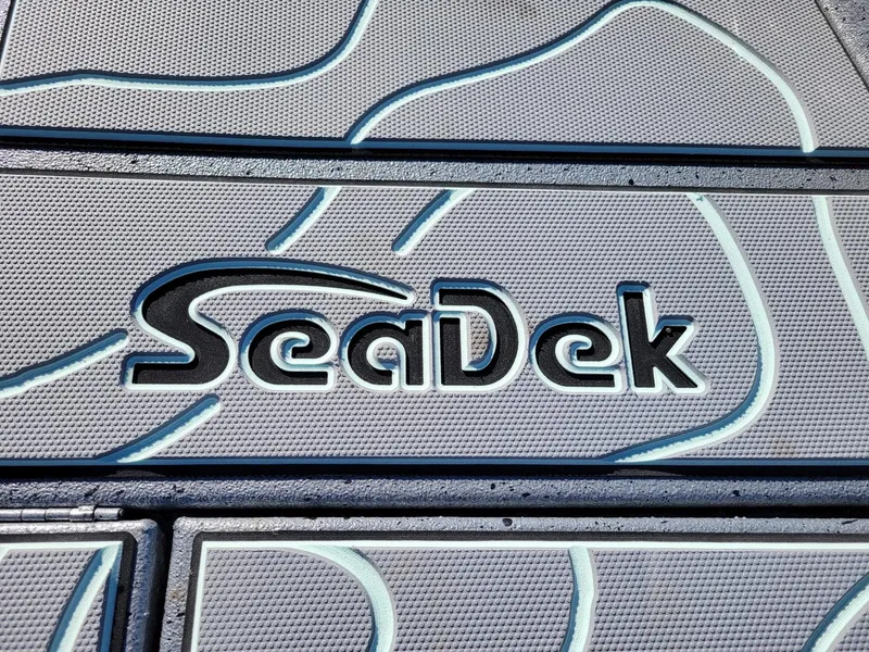 Slide: The Image of SeaDek logo on Xpress X23 Bay Lounge 2024 boat flooring, showcasing textured design. - 3