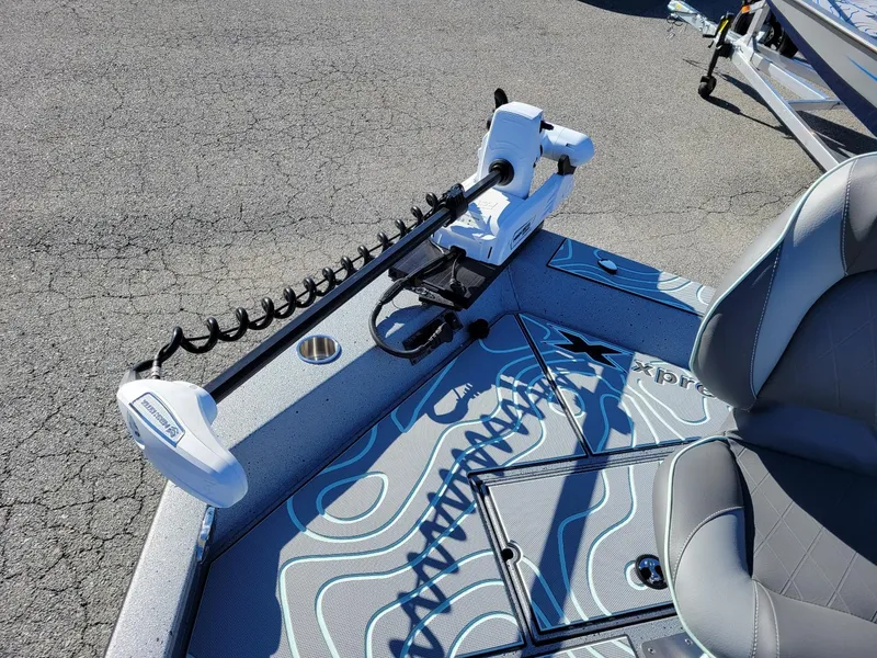 Slide: The Image of 2024 Xpress X23 Bay Lounge boat deck with trolling motor and seating. - 5