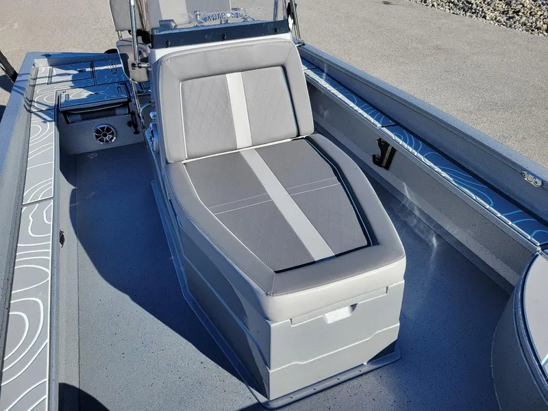 Slide: The Image of 2024 Xpress X23 Bay Lounge boat interior with gray seating and modern design. - 6
