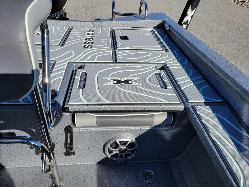 Slide: The Image of 2024 Xpress X23 Bay Lounge boat interior with stylish deck design and storage compartments. - 8