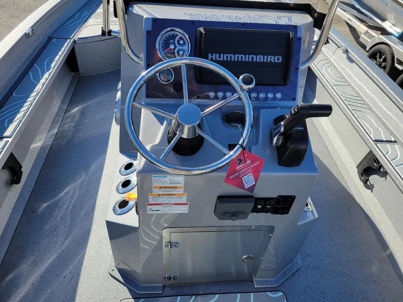 Slide: The Image of 2024 Xpress X23 Bay Lounge boat console with steering wheel and Humminbird display. - 9